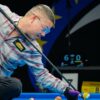 Predator player lining up a shot with a pool cue